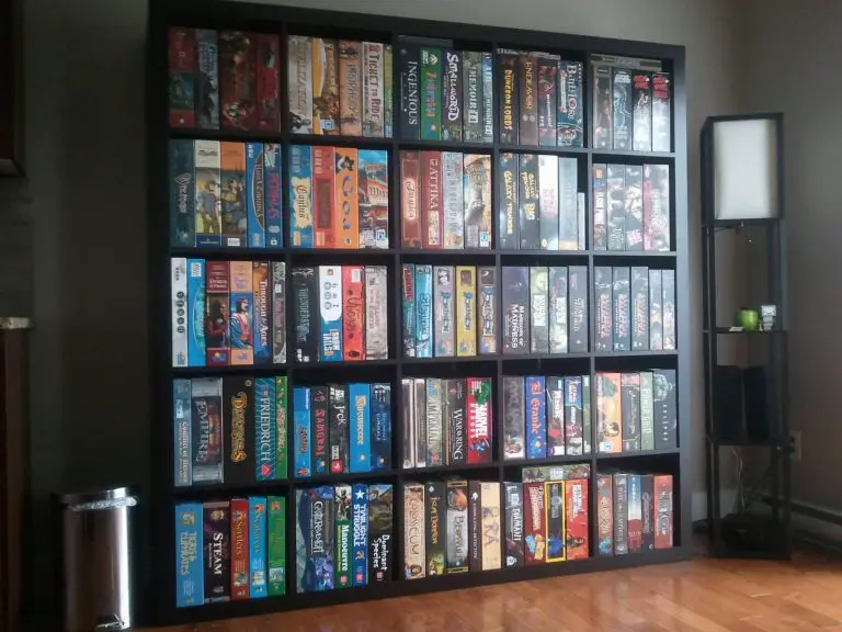 A Kallax bookshelf full of boardgames in someone's home.